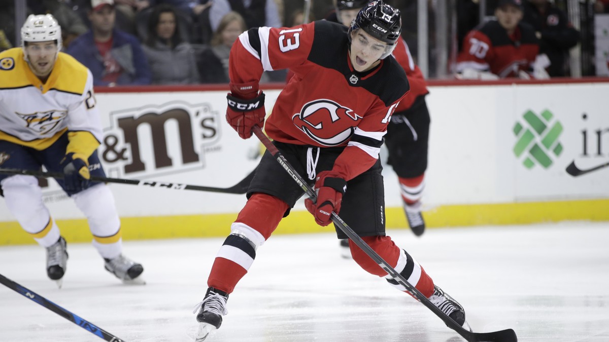 New Jersey Devils center Nico Hischier (13), of Switzerland, shoots against the Nashville Predators during the second period of an NHL hockey game, Thursday, Jan. 25, 2018, in Newark, N.J. (AP Photo/J ...