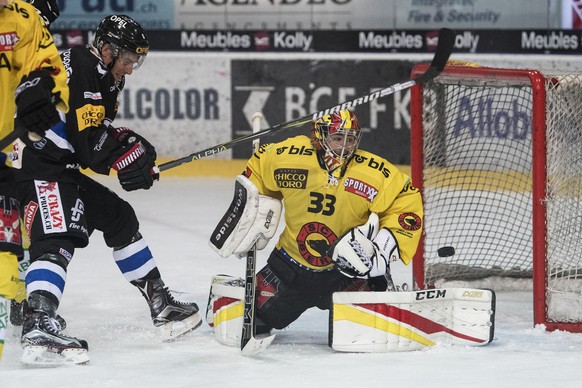 Fribourgs Christopher Rivera, links, im Duell mit Berns Goalie Pascal Caminada im Eishockey Meisterschaftsspiel der National League zwischen dem HC Fribourg-Gotteron und dem SC Bern, am Samstag, 7. Ok ...