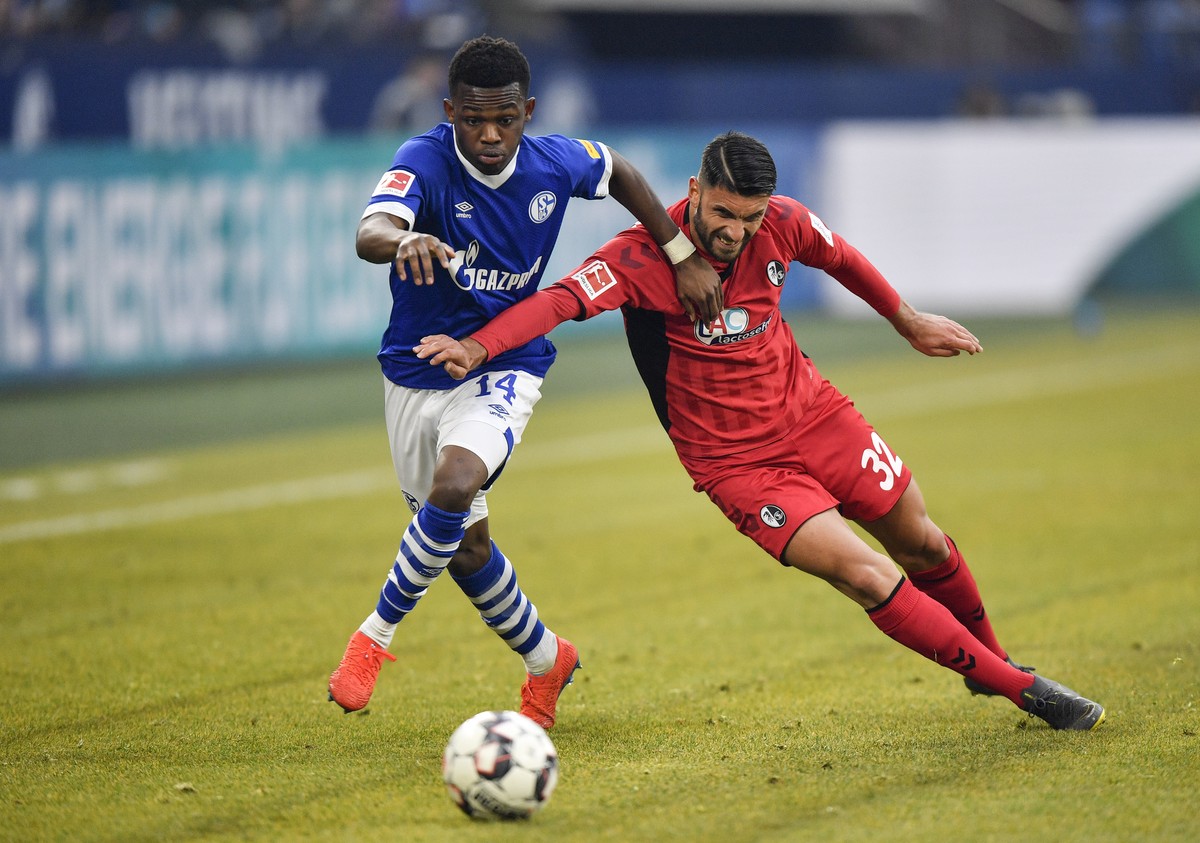 Freiburg's Vincenzo Grifo, right, and Schalke's Rabbi Matondo challenge for the ball during the German Bundesliga soccer match between FC Schalke 04 and SC Freiburg in Gelsenkirchen, Germany ...