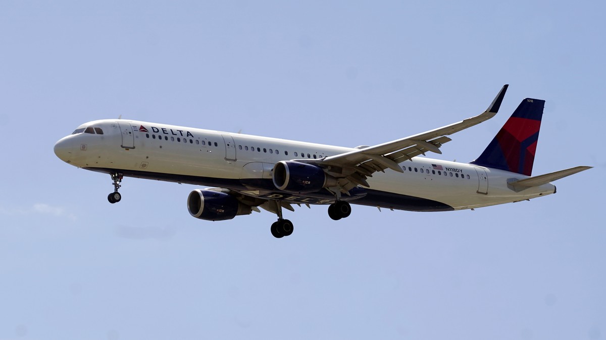 FILE - A Delta Air Line plane flies arrives at Salt Lake City International Airport, June 30, 2022, in Salt Lake City. A Delta flight from Detroit to Amsterdam was diverted to New York's Kennedy  ...