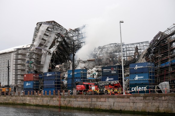 epa11287714 General view shows the ruins of the historical building Boersen, the former Stock Exchange, after its outer wall collapsed in a fire, in Copenhagen, Denmark, 19 April 2024. The fire broke  ...