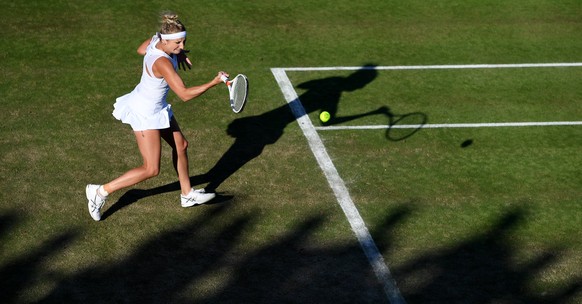 epa06066289 Timea Bacsinszky of Switzerland in action against Monica Puig of Puerto Rico during their first round match for the Wimbledon Championships at the All England Lawn Tennis Club, in London,  ...