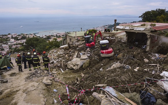 Search teams work on a landslide in Casamicciola, on the Italian resort island of Ischia, in southern Italy, Wednesday, Nov. 30, 2022, which killed eight people and left four missing where a big chunk ...