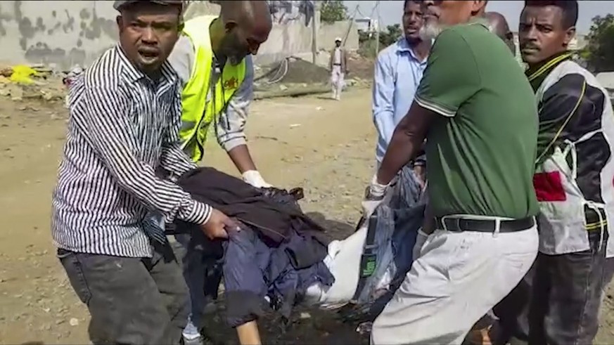 In this image made from video, medics carry the body of a dead or injured victim of an airstrike in Mekele, capital of the Tigray region of northern Ethiopia Wednesday, Sept. 14, 2022. Two airstrikes  ...
