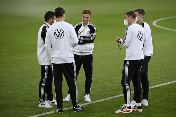 Germany&#039;s Joshua Kimmich, center, talks with teammates on the pitch before the international friendly soccer match between Germany and Denmark at the Tivoli Stadion Tirol in Innsbruck, Austria, W ...