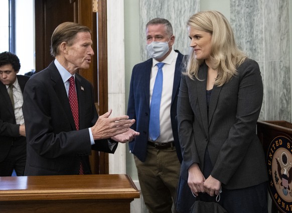 Sen. Richard Blumenthal, D-Conn., center, speaks with former Facebook employee and whistleblower Frances Haugen as she arrives to testify before a Senate Committee on Commerce, Science, and Transporta ...