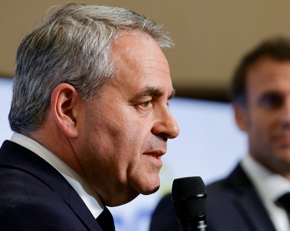 epa10623367 French President Emmanuel Macron (R) looks on as President of the Regional Council of Hauts-de-France Xavier Bertrand speaks at the Dunkirk Urban Community offices in Dunkerque, the city p ...