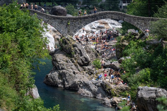 A few bathers seeking relief from the heat in the waters of the River Verzasca; in Ticino, a level 3 heatwave warning is in place due to high temperatures and sweltering heat; today the temperature re ...