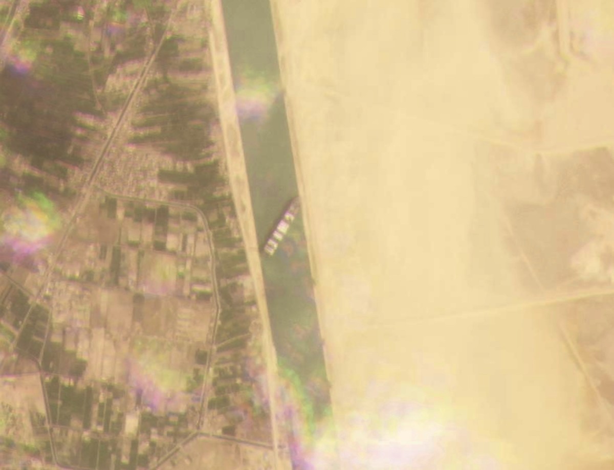This satellite image from Planet Labs Inc. shows the cargo ship MV Ever Given stuck in the Suez Canal near Suez, Egypt, Tuesday, March 23, 2021. A cargo container ship that's among the largest in ...