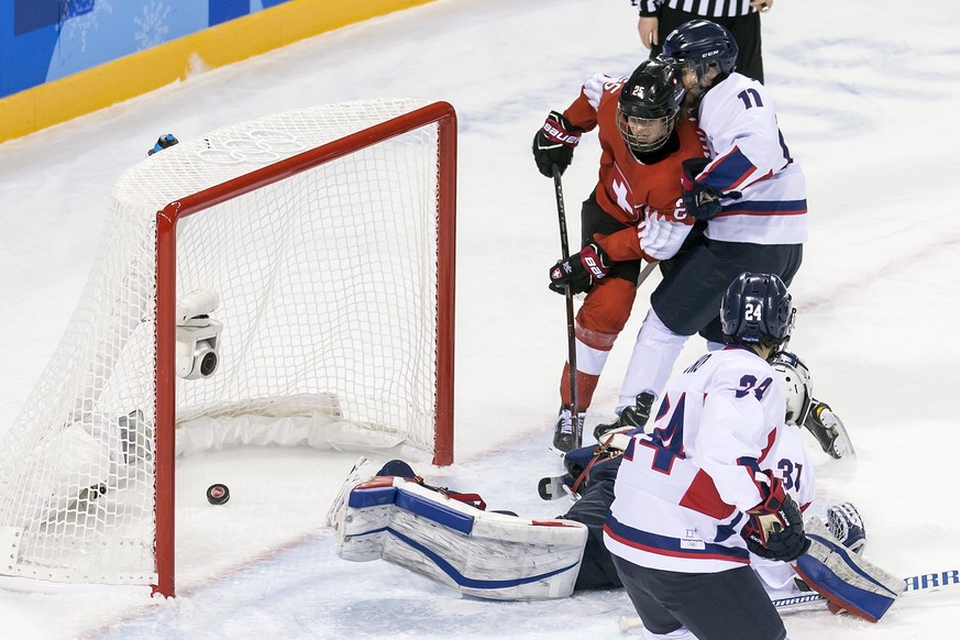 Alina Muller of Switzerland, left, South Korea&#039;s Ye Eun Park, Mihwan Cho, So Jung Shin and Soojin Han, of the combined Koreas team, from left, battle for the puck during the women ice hockey prel ...