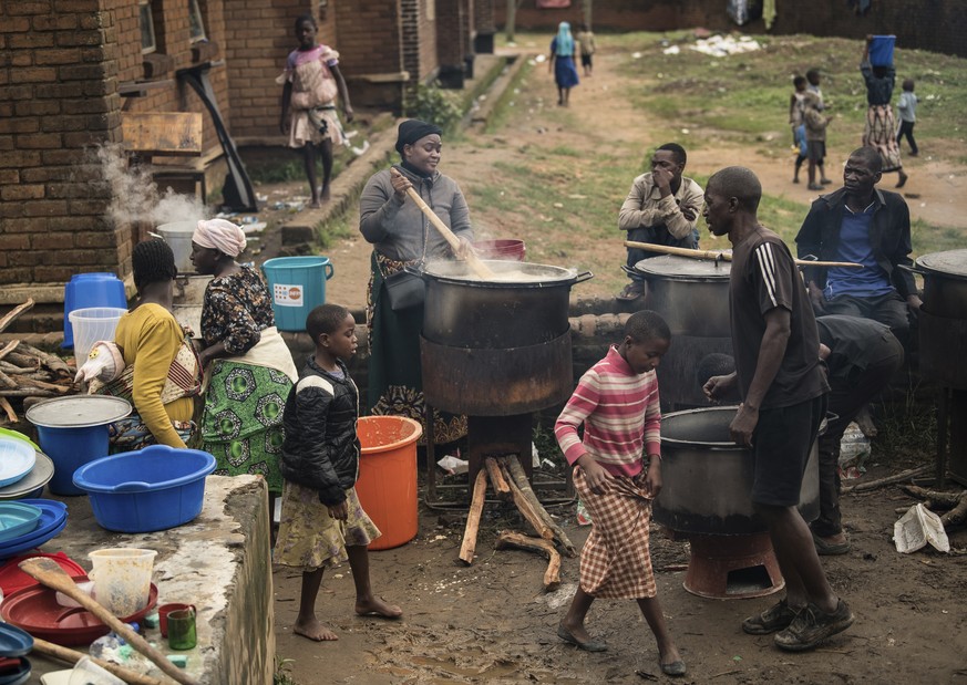 Community volunteers prepare meals for people displaced following heavy rain from Tropical Cyclone Freddy at Manja displacement center in Blantyre, southern Malawi, Thursday, March 16, 2023. A…