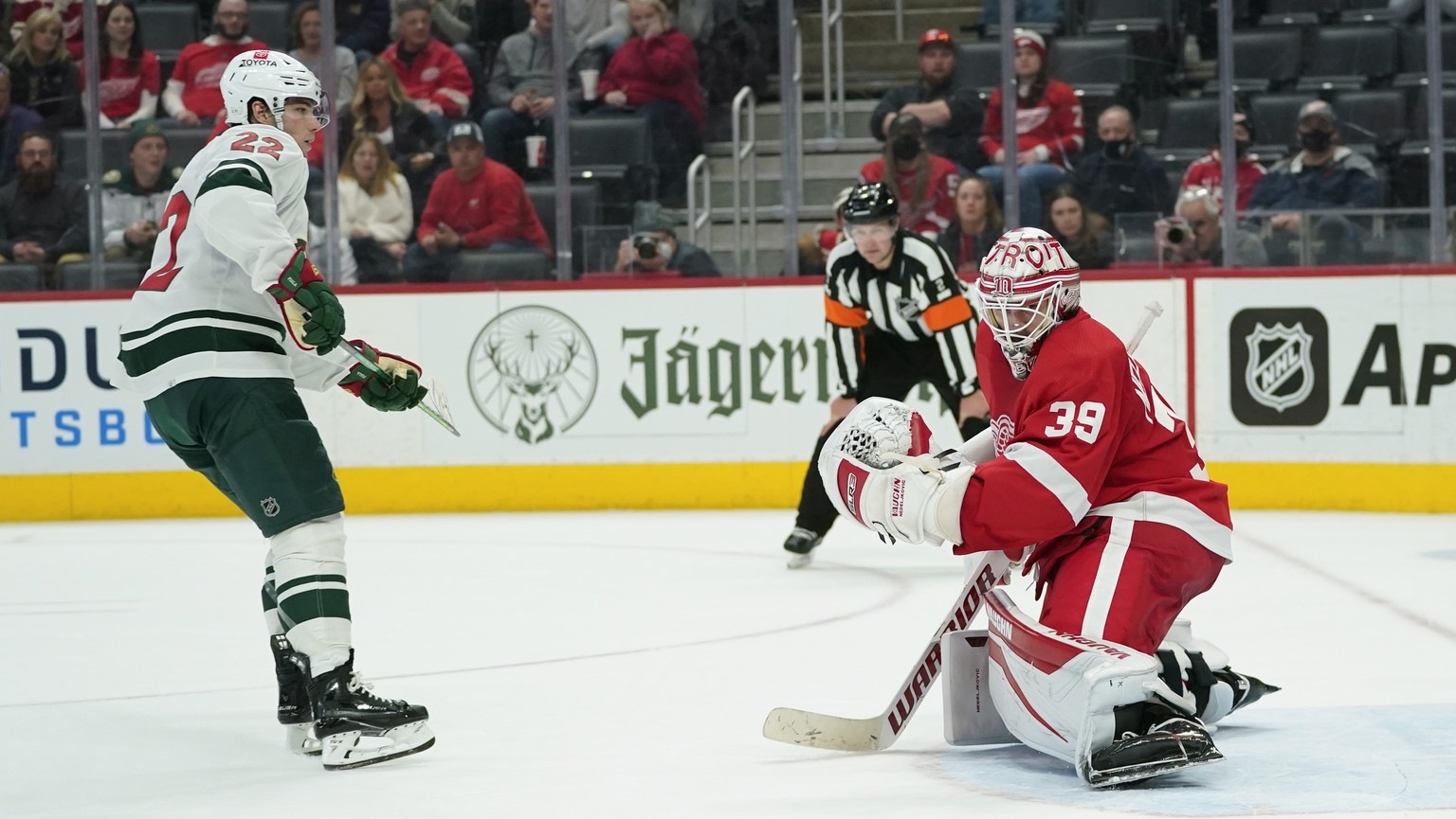 Minnesota Wild left wing Kevin Fiala (22) scores on Detroit Red Wings goaltender Alex Nedeljkovic (39) during a shootout in an NHL hockey game Thursday, March 10, 2022, in Detroit. Minnesota won 6-5.  ...