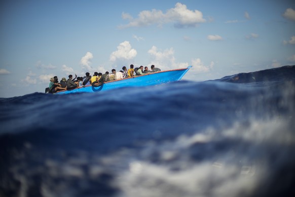 FILE - Migrants sail a wooden boat at south of the Italian Lampedusa island at the Mediterranean sea, Aug. 11, 2022. The back-to-back shipwrecks of migrant boats off Greece that left at least 22 peopl ...