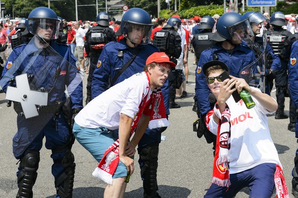 Sion&#039;s fans take a selfie in front of Swiss riot police during the Swiss Cup final soccer match between FC Basel and FC Sion at the St. Jakob-Park stadium in Basel, Switzerland, Sunday, June 7, 2 ...