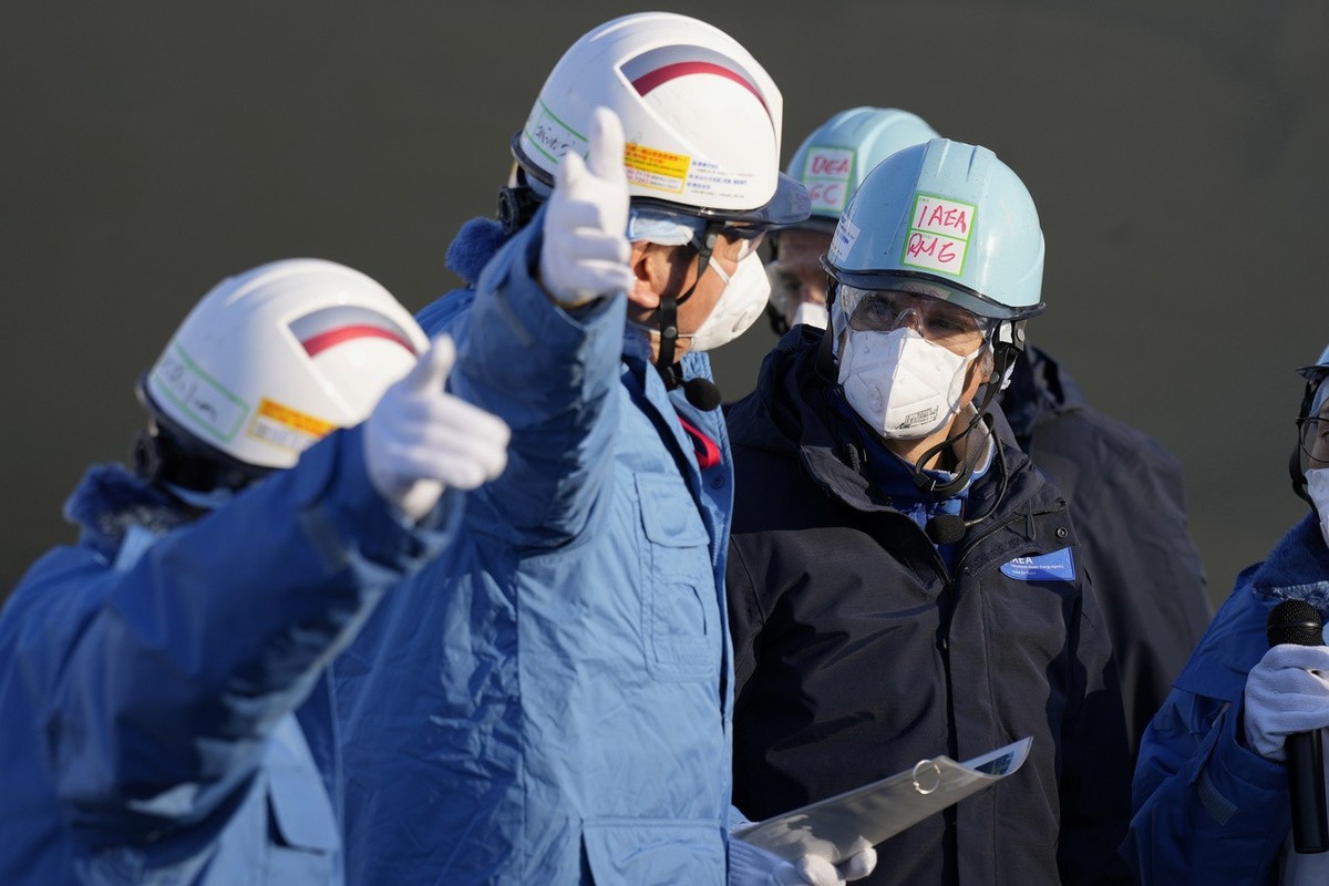 International Atomic Energy Agency Director General Rafael Mariano Grossi, right, is guided by Tokyo Electric Power Co. (TEPCO) President Tomoaki Kobayakawa, left, at a facility for sampling treated a ...