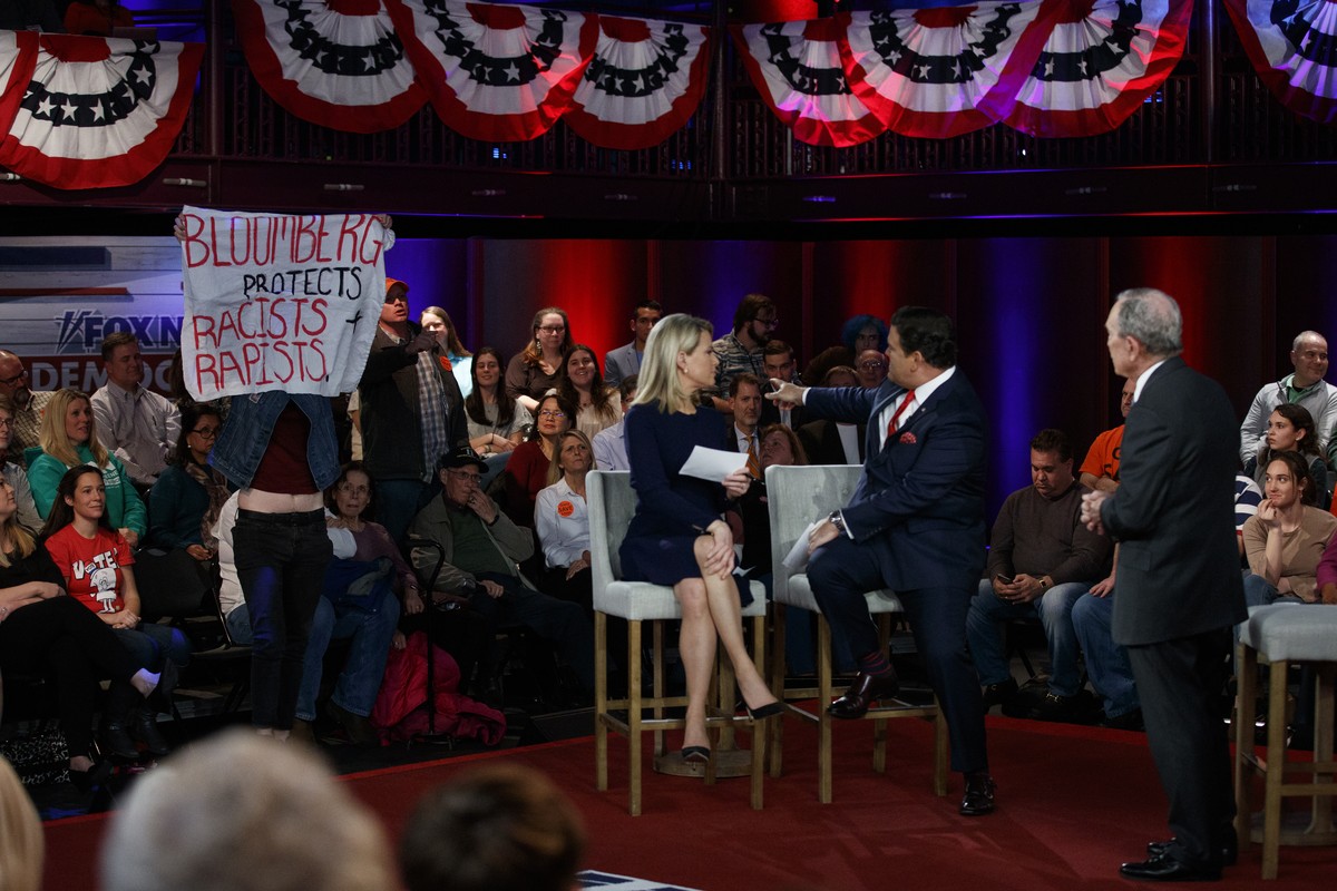Democratic presidential candidate former New York City Mayor Mike Bloomberg looks to a protester during a FOX News Channel Town Hall, co-moderated by FNC's chief political anchor Bret Baier of Sp ...