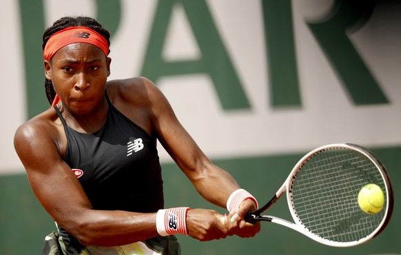 epa09245136 Coco Gauff of the USA in action against Wang Qiang of China during their second round match at the French Open tennis tournament at Roland Garros in Paris, France, 03 June 2021. EPA/YOAN V ...