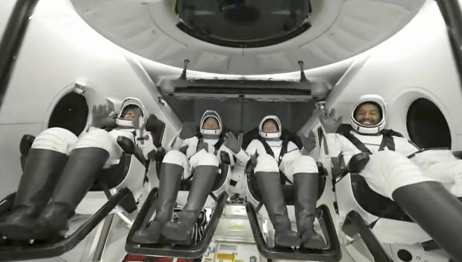In this image taken from video broadcast by SpaceX, crew members wave after the SpaceX Dragon capsule splashed down into the Gulf of Mexico, just off the Florida Panhandle, late Tuesday, May 30, 2023. ...