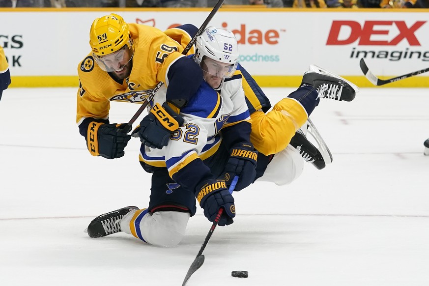 Nashville Predators&#039; Roman Josi (59) and St. Louis Blues&#039; Noel Acciari (52) battle for the puck in the first period of an NHL hockey game Thursday, Oct. 27, 2022, in Nashville, Tenn. (AP Pho ...