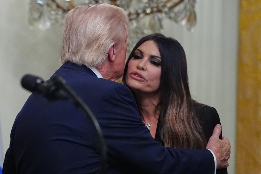 President Donald Trump embraces U.S. Ambassador to Greece Kimberly Guilfoyle at a reception celebrating Greek Independence Day, in the East Room of the White House, Thursday, March 26, 2026, in Washin ...