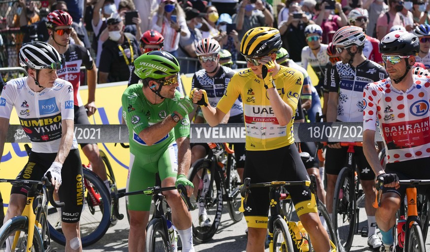 Slovenia&#039;s Tadej Pogacar, wearing the overall leader&#039;s yellow jersey, Britain&#039;s Mark Cavendish, wearing the best sprinter&#039;s green jersey, Netherlands Wout Poels, wearing the best c ...