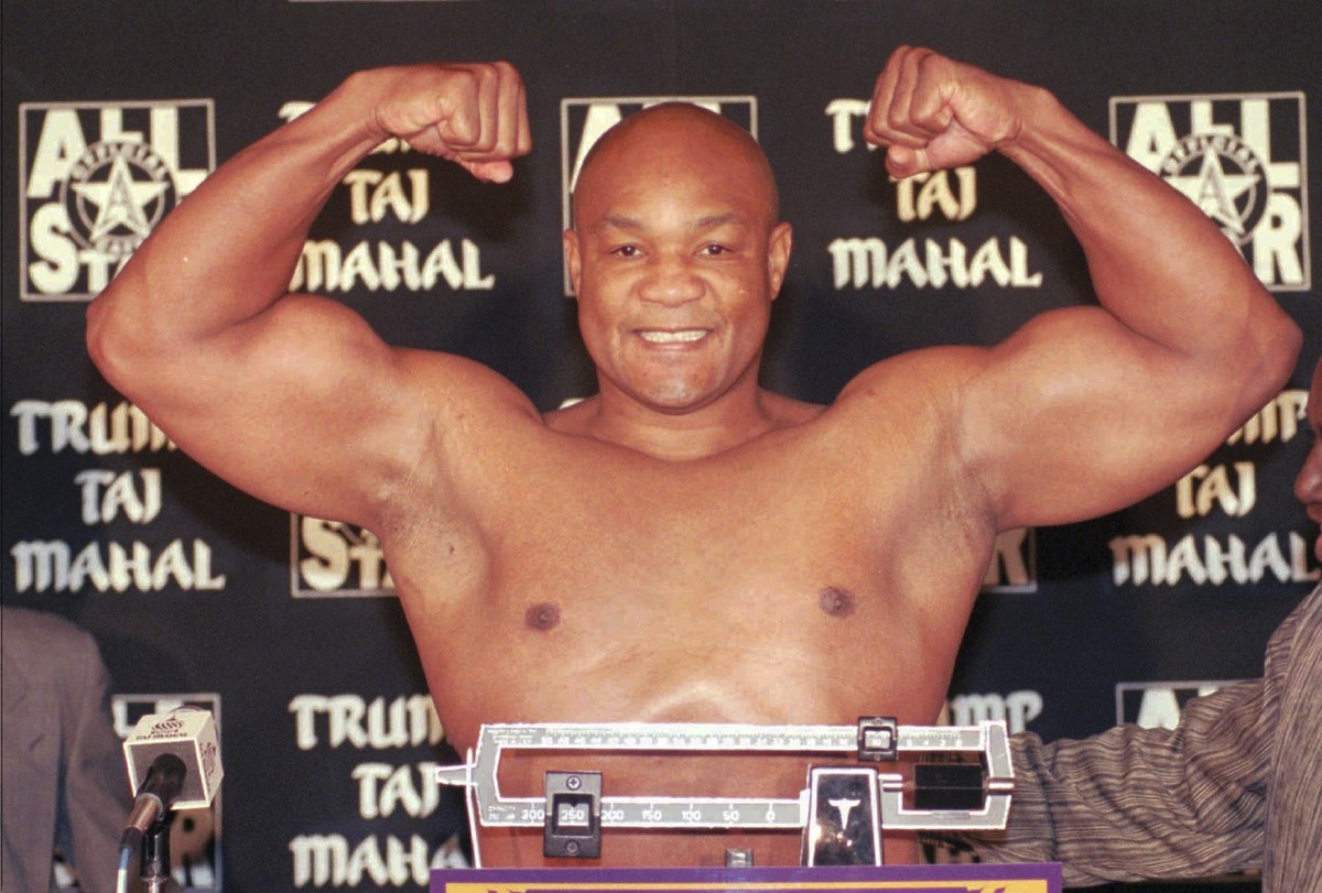 FILE - Heavyweight boxer George Foreman flexes his muscles after weighing in at 260 pounds for his upcoming fight against Shannon Briggs at the Trump Taj Mahal Casino Resort in Atlantic City., N.J., T ...
