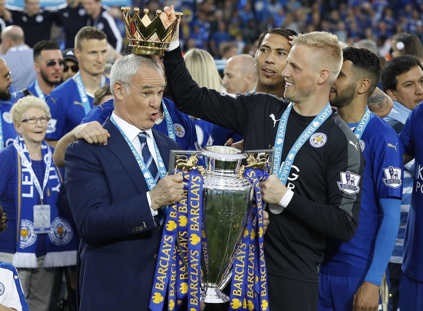 FILE - In this Saturday, May 7, 2016 file photo Leicester City team manager Claudio Ranieri has the crown of the trophy placed on his head by Leicester goalkeeper Kasper Schmeichel as they celebrate b ...