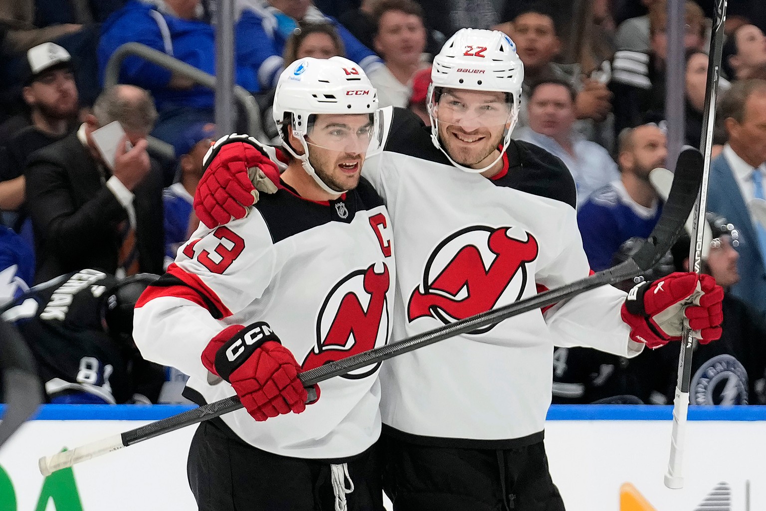 KEYPIX - New Jersey Devils center Nico Hischier (13) celebrates his goal against the Tampa Bay Lightning with defenseman Brett Pesce (22) during the first period of an NHL hockey game Saturday, Oct. 1 ...