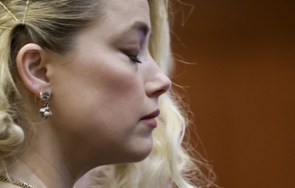 Actor Amber Heard waits before the verdict was read at the Fairfax County Circuit Courthouse in Fairfax, Va, Wednesday, June 1, 2022. The jury awarded Johnny Depp more than $10 million in his libel la ...