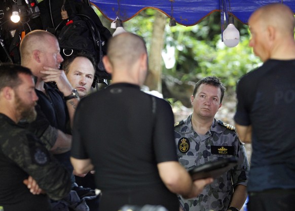 epa06854054 Australian aid authorities talk each other as they join the search and rescue operations near the Tham Luang cave in Tham Luang Khun Nam Nang Noon Forest Park in Chiang Rai province, Thail ...