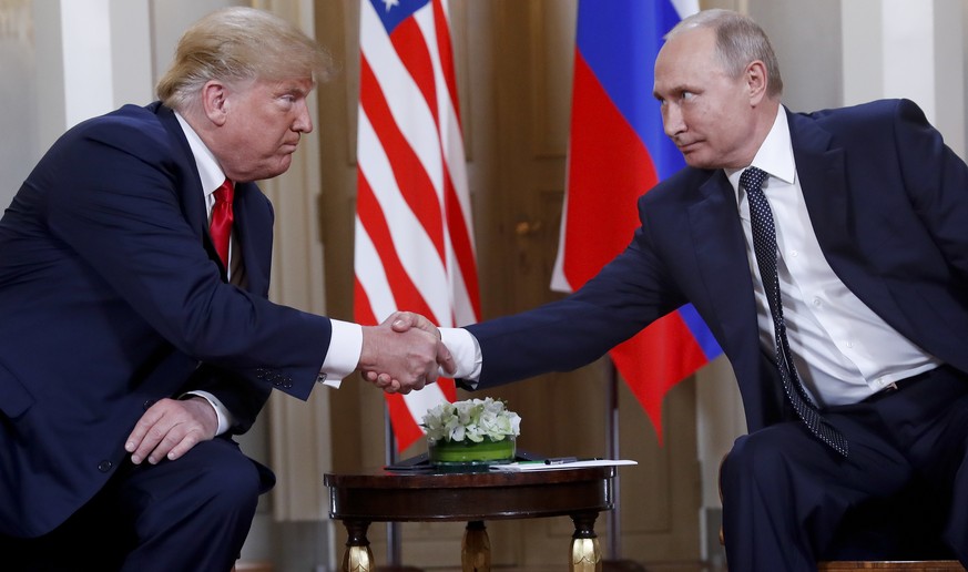 FILE- In this file photo taken on Monday, July 16, 2018, U.S. President Donald Trump, left, and Russian President Vladimir Putin, shake hands at the beginning of a meeting at the Presidential Palace i ...