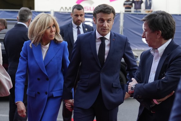 Centrist candidate and French President Emmanuel Macron and his wife Brigitte Macron arrive at a television recording studio for a debate with centrist candidate and French President Emmanuel Macron,  ...