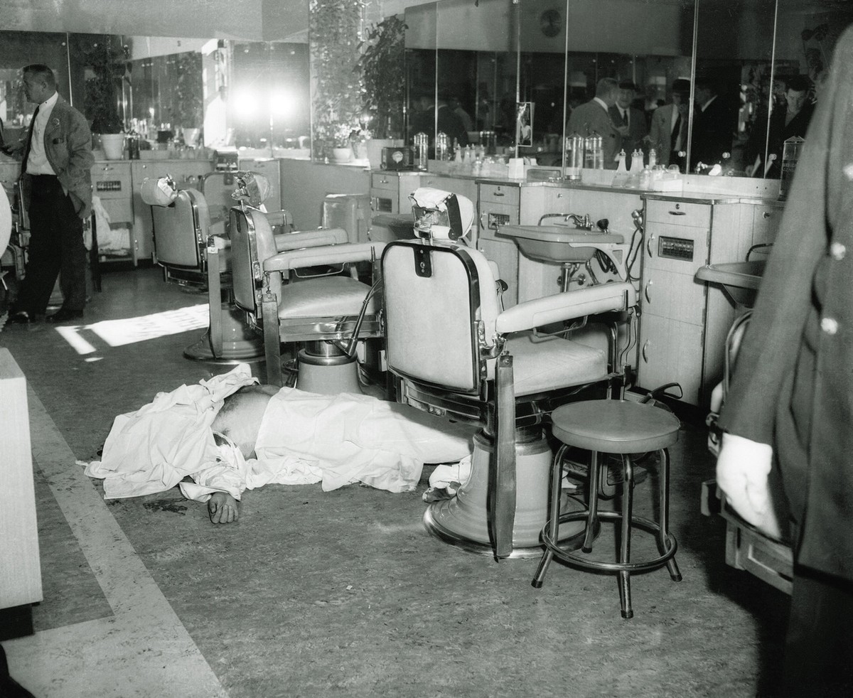 The body of Mafia boss Albert Anastasia lies on the floor of the barbershop at New York's Park Sheraton Hotel after his murder, in this October 1957, file photo. Anastasia was a friend of fellow  ...