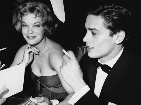 FILE - Romy Schneider and French actor Alain Delon, recently engaged, sit with friends attending the Easter Gala on March 30, 1959 at the Sporting Club of Monaco. (AP Photo, File)