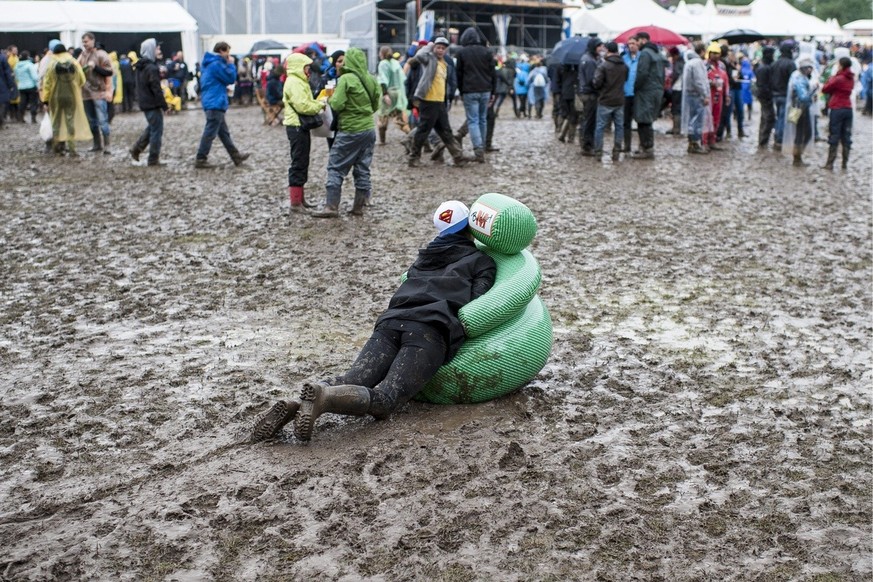 A visitor is playing in the mud at the OpenAir St. Gallen on Saturday, June 29, 2013, in St. Gallen. The OpenAir St.Gallen is one of the oldest outdoor festivals in Switzerland. It&#039;s close to the ...