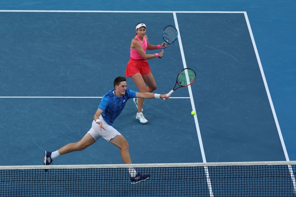 MELBOURNE, AUSTRALIA - JANUARY 22: Henry Patten (L) of Great Britain plays a forehand as he plays with Olivia Nicholls (R) of Great Britain in the Mixed Doubles Semifinal against Kimberly Birrell and  ...