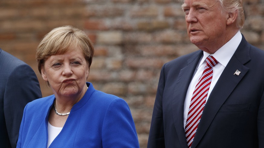 German Chancellor Angela Merkel and President Donald Trump pose for a family photo with G7 leaders at the Ancient Greek Theater of Taormina, Friday, May 26, 2017, in Taormina, Italy. (AP Photo/Evan Vu ...