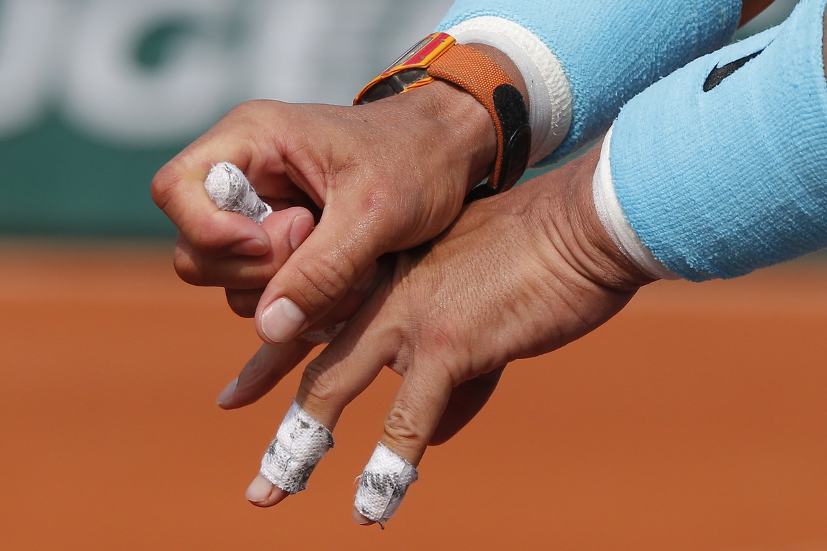 Spain's Rafael Nadal bend his finger in the men's final match of the French Open tennis tournament against Austria's Dominic Thiem at the Roland Garros stadium in Paris, France, Sunday, ...