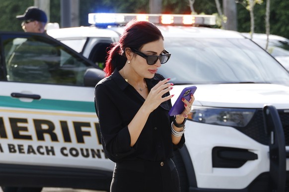 Laura Loomer uses her cell phone near Trump International Golf Club after police closed off the area following the apparent assassination attempt of Republican presidential nominee former President Do ...