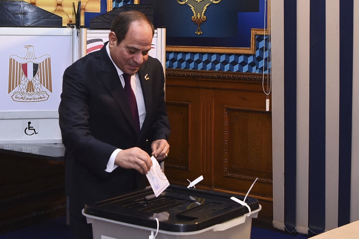 In this photo provided by Egypt's presidency media office, Egyptian President Abdel Fattah el-Sissi, casts his vote for the presidential elections at a polling station, in Cairo, Egypt, Sunday, D ...