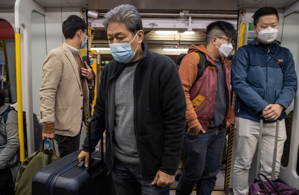 epa10395070 Travellers board the first train to Lok Ma Chau station, a border crossing point with China, in Hong Kong, China, 08 January 2023. From 08 January 2023, after three years of closures due t ...