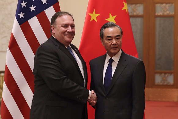 U.S. Secretary of State Mike Pompeo, left, shakes hands with Chinese Foreign Minister Wang Yi as they pose for photograph at the Great Hall of the People in Beijing, Thursday, June 14, 2018. (AP Photo ...