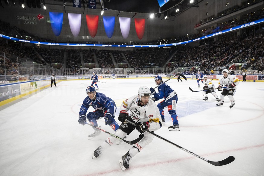 Zuerichs Reto Schaeppi, links, kaempft um den Puck gegen Gotterons Samuel Walser, rechts, im Eishockeyspiel der National League zwischen den ZSC Lions und dem HC Fribourg-Gotteron am Dienstag, 18. Okt ...