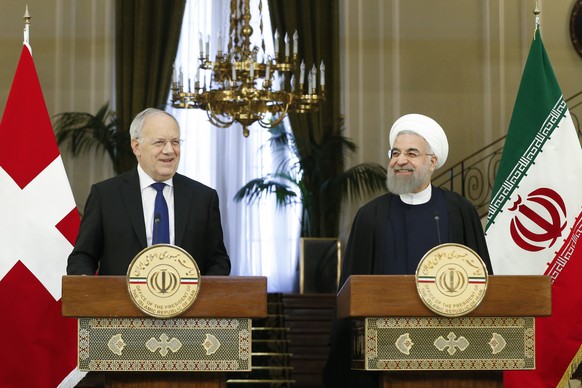 Swiss Federal President Johann Schneider-Ammann, left, and Hassan Rohani, President of the Islamic Republic of Iran, right, attend a press conference at the Saadabad Palace in Teheran, Iran, Saturday, ...