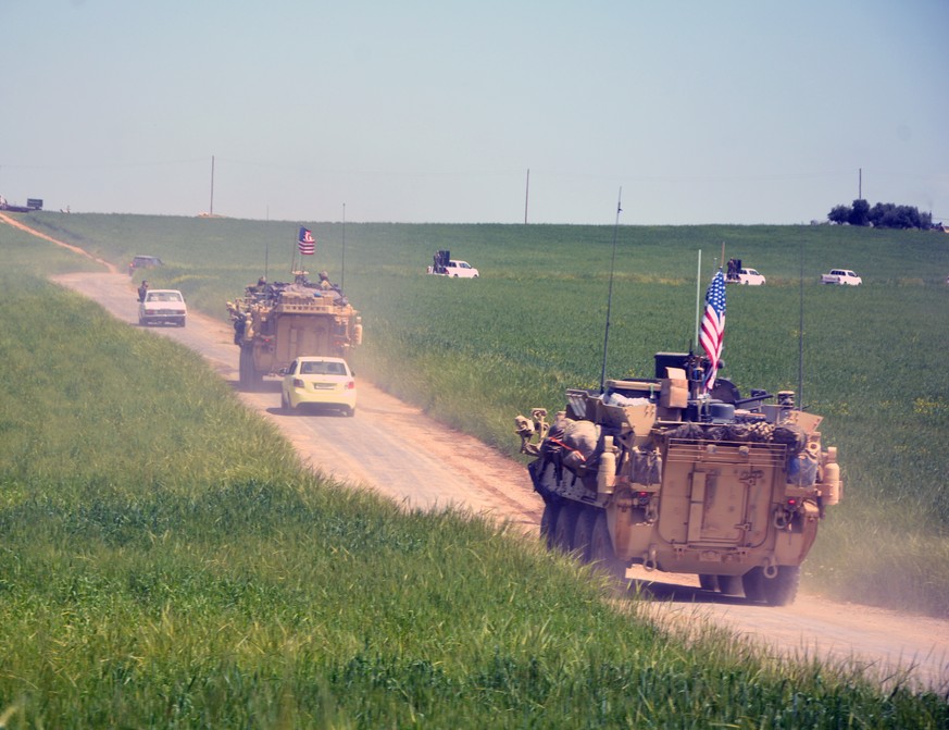 epa07240227 (FILE) - A convoy of US army troops and the People&#039;s Protection Units (YPG) Kurdish militia patrol near al-Ghanamya village, al-Darbasiyah town at the Syrian-Turkish border, Syria, 29 ...