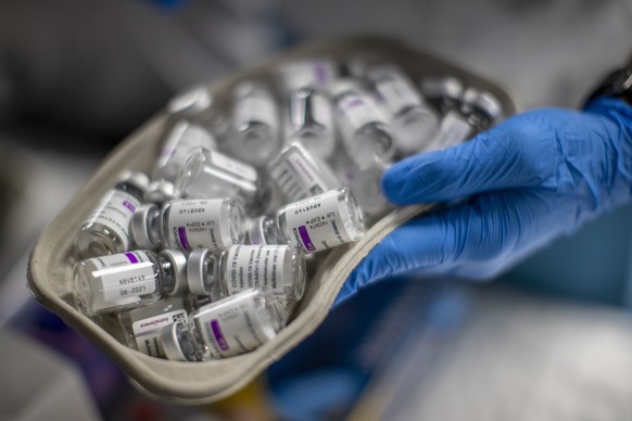 FILE - A nurse holds vials of AstraZeneca vaccine against COVID-19 during a vaccination campaign at WiZink indoor arena in Madrid, April 9, 2021. Police in Italy, Austria, Romania and Slovakia arreste ...