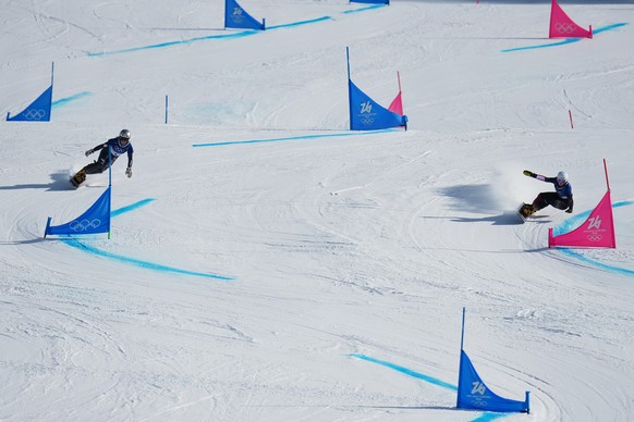 Czechia's Ester Ledecka, left, and Austria's Sabine Payer compete during the women's snowboarding parallel giant slalom finals at the 2026 Winter Olympics, in Livigno, Italy, Sunday, Fe ...