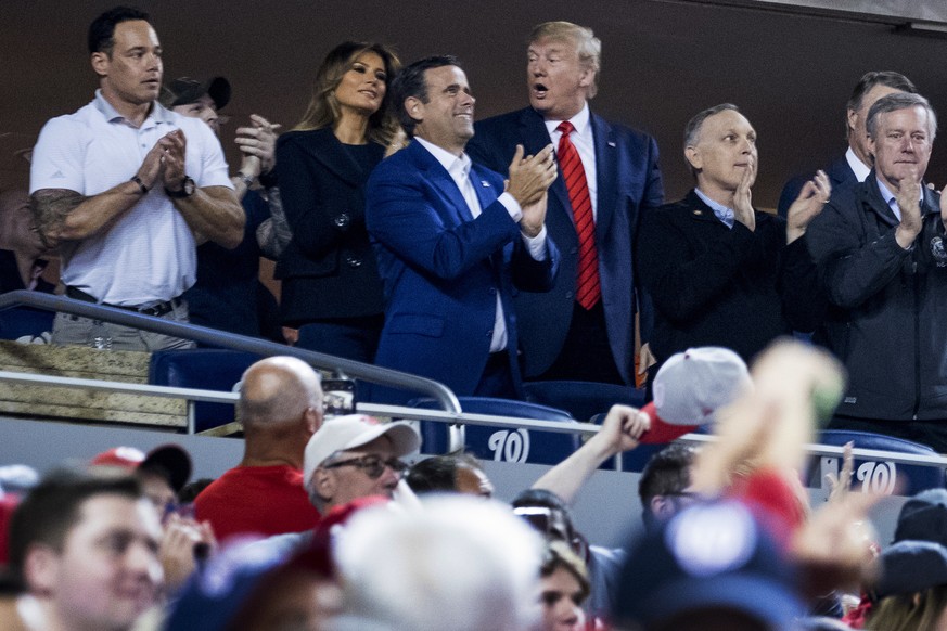 President Donald Trump, third from right, accompanied by first lady Melania Trump, second from left, and Republican lawmakers, reacts as the stadium boos when he is shown on the jumbo screen during a  ...