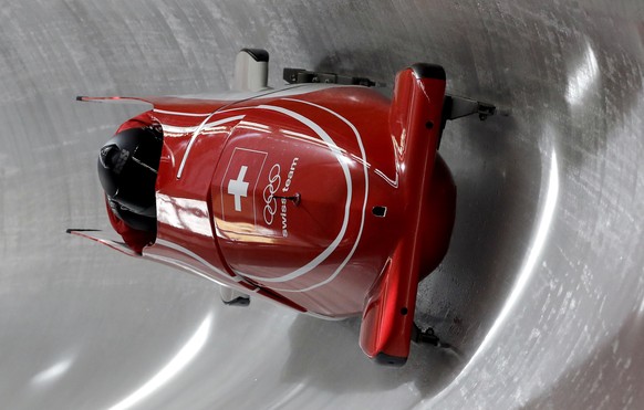 Driver Rico Peter and Simon Friedli of Switzerland slide down the track during a two-man bobsled training run at the 2018 Winter Olympics in Pyeongchang, South Korea, Saturday, Feb. 17, 2018. (AP Phot ...