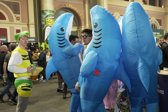 Fans dressed in costumes wait for the start of the final match between Luke Littler of England and Luke Humphries of England at the World Darts Championship, in London, Wednesday, Jan. 3, 2024. (AP Ph ...